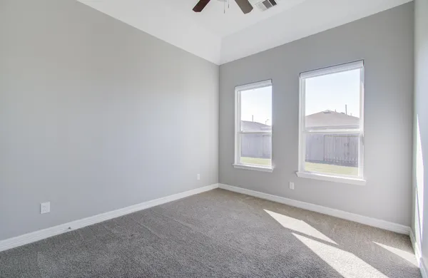 an empty room with windows and closet