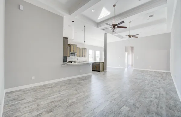 a view of a kitchen with a sink and wooden floor