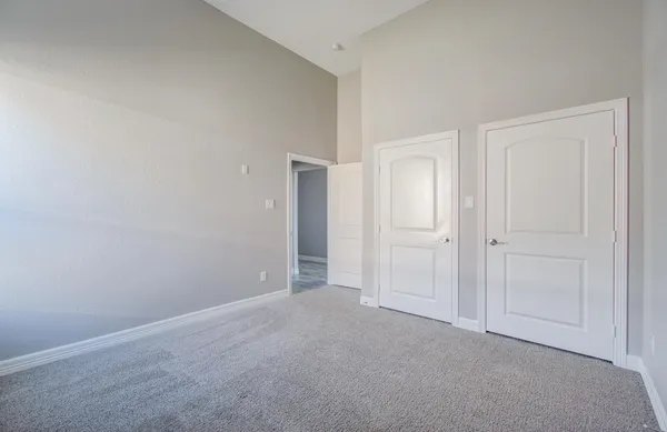 a view of an empty room and closet area