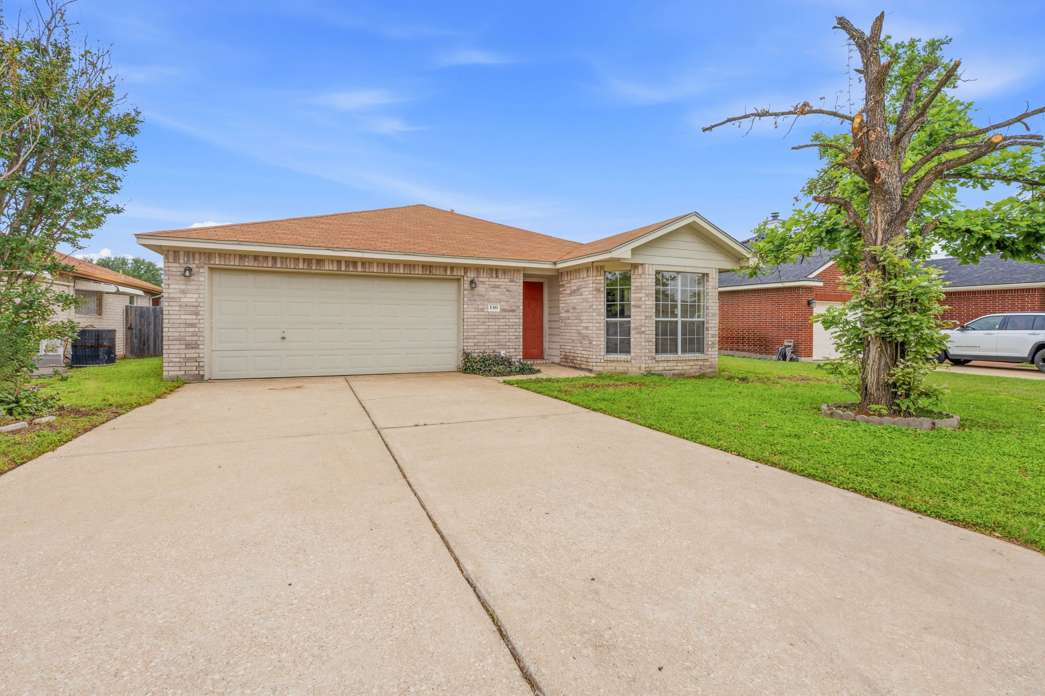 116 Blue Ridge Trail Elgin, TX 78621 - Photo 28 of 28 a front view of a house with a garden and trees