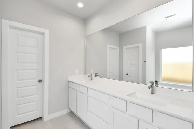 a spacious bathroom with a bathtub shower and double sink