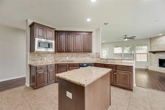 a kitchen that has a sink and a stove in it