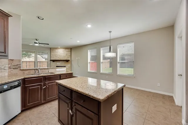 a kitchen with stainless steel appliances granite countertop a sink and a stove