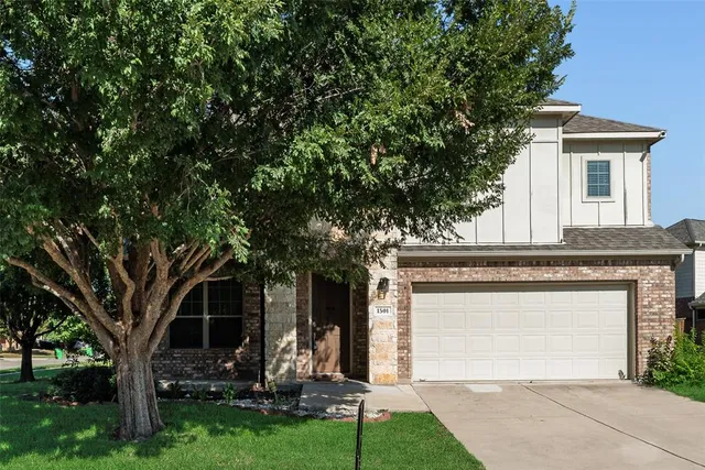 front view of a house with a tree