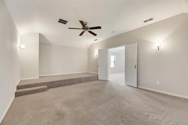 a view of a livingroom with a ceiling fan and window