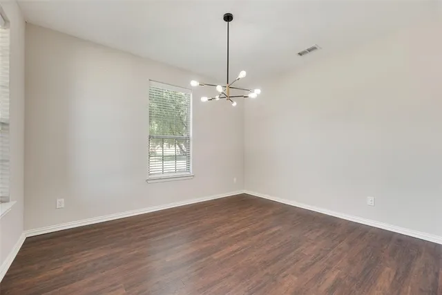 a view of a room with wooden floor fan and window