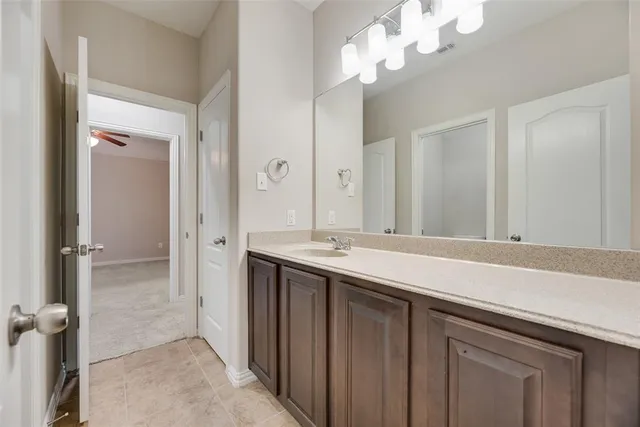 a bathroom with a sink a mirror and a shower