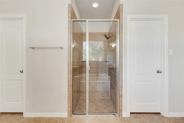 a bathroom with a glass shower door
