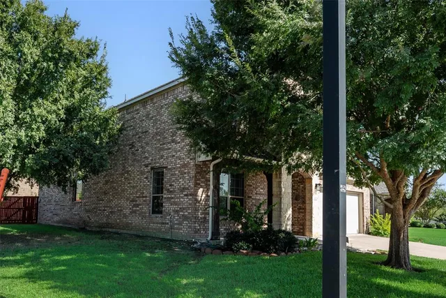 front view of a house with a tree