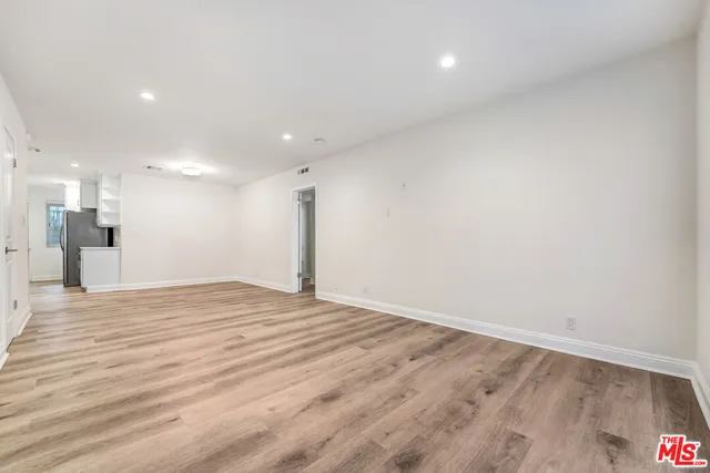 a view of a kitchen with a sink and a refrigerator