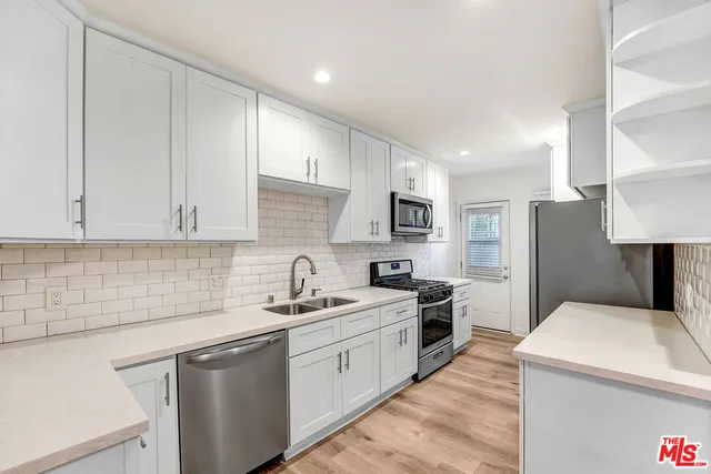 a kitchen with a sink stove and refrigerator