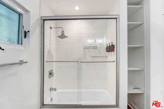 a bathroom with a glass shower door