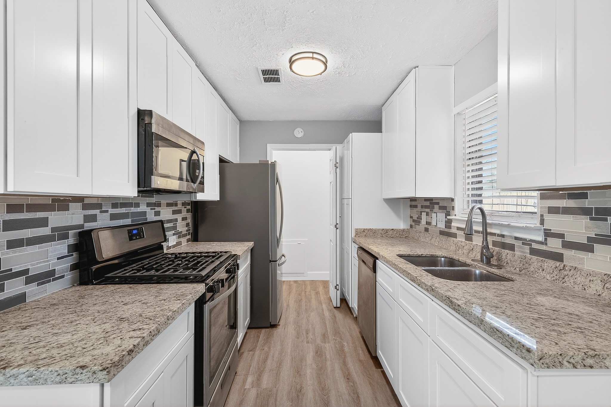 2510 Marble Falls Drive Spring, TX 77373 - Photo 8 of 26 a kitchen with a sink stove top oven and refrigerator
