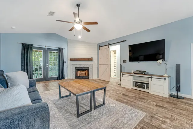 a living room with furniture and a flat screen tv