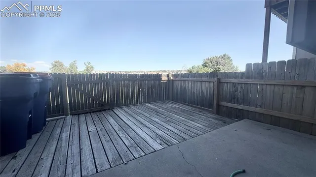 a view of a swimming pool with a patio and a yard