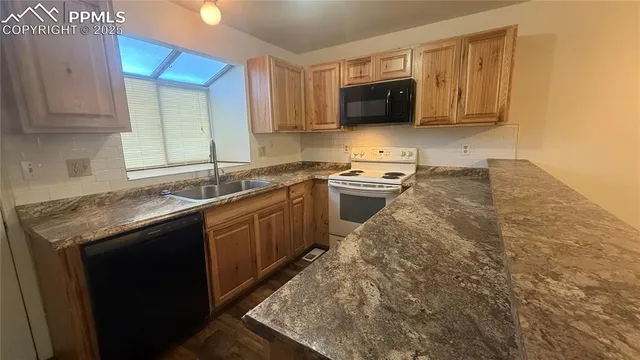 a kitchen with stainless steel appliances granite countertop a sink stove and microwave