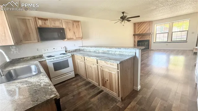 a kitchen with granite countertop a stove and a sink