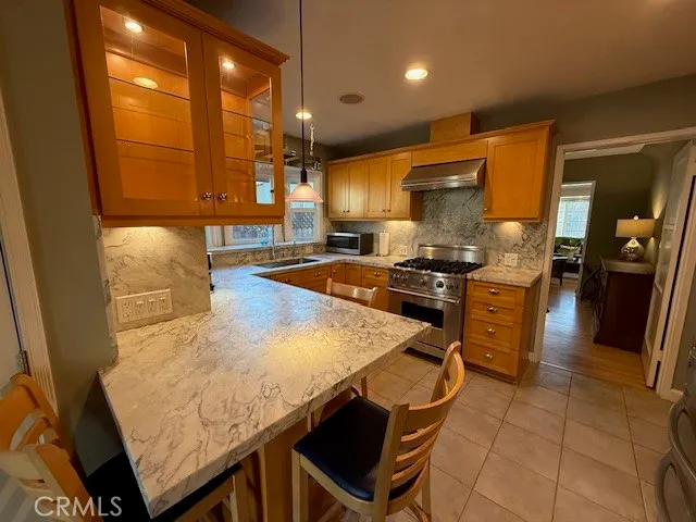 a kitchen with stainless steel appliances kitchen island granite countertop a sink and cabinets