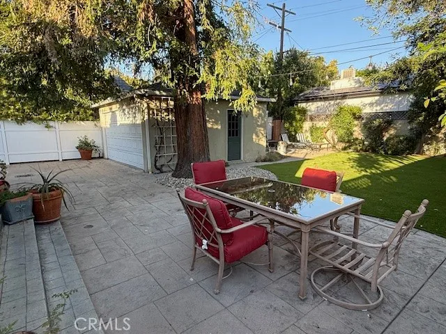a backyard of a house with table and chairs