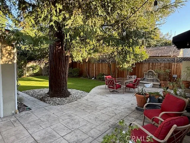 a view of backyard with swimming pool and sitting area