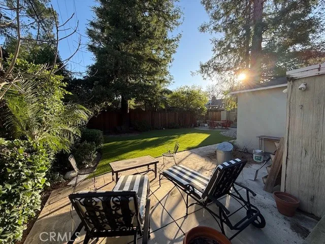 a view of a swimming pool with lounge chair and trees