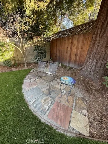 a backyard of a house with table and chairs
