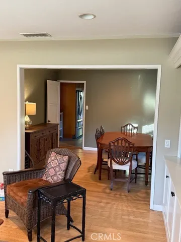 a dining room with furniture and wooden floor