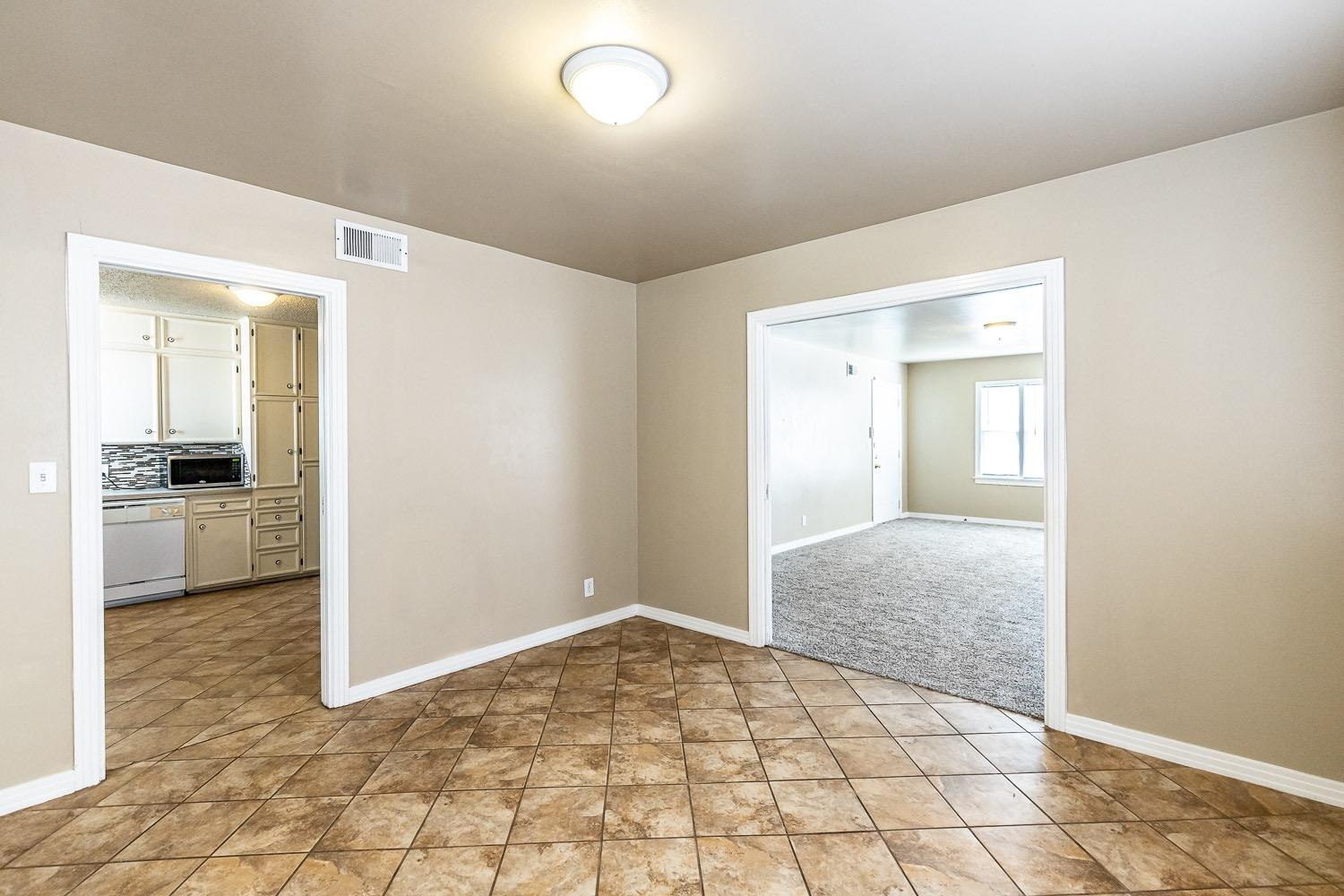 3708 27th Street Lubbock, TX 79410 - Photo 7 of 23 a view of a hallway to a livingroom with wooden floor