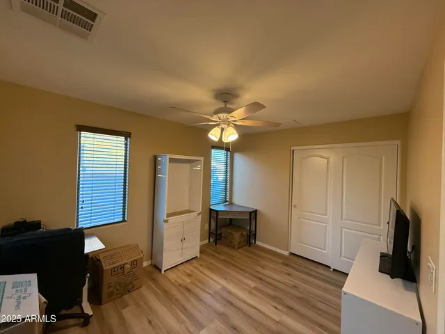 a kitchen with granite countertop sink refrigerator and cabinets