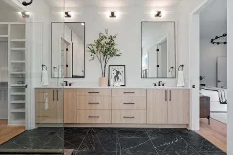 an empty room with wooden floor and ceiling fan