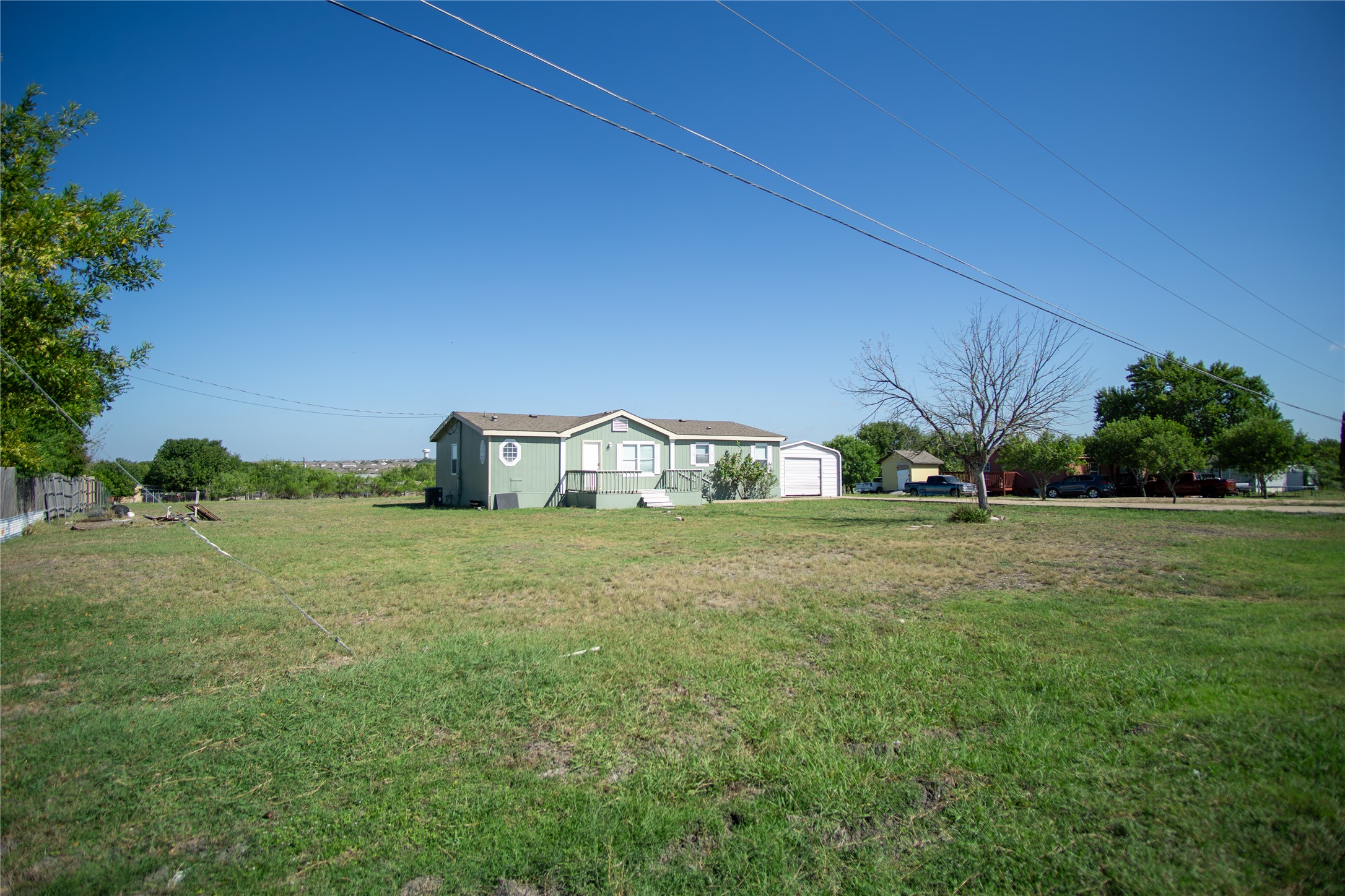 View of grassy yard with a garage