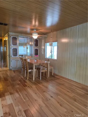a view of a kitchen with furniture and stainless steel appliances