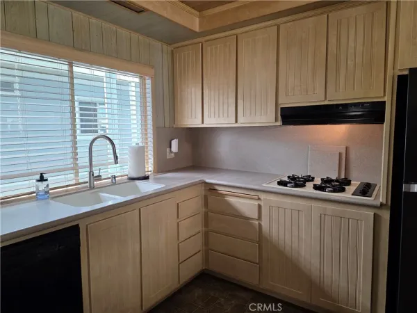a kitchen with a refrigerator and cabinets