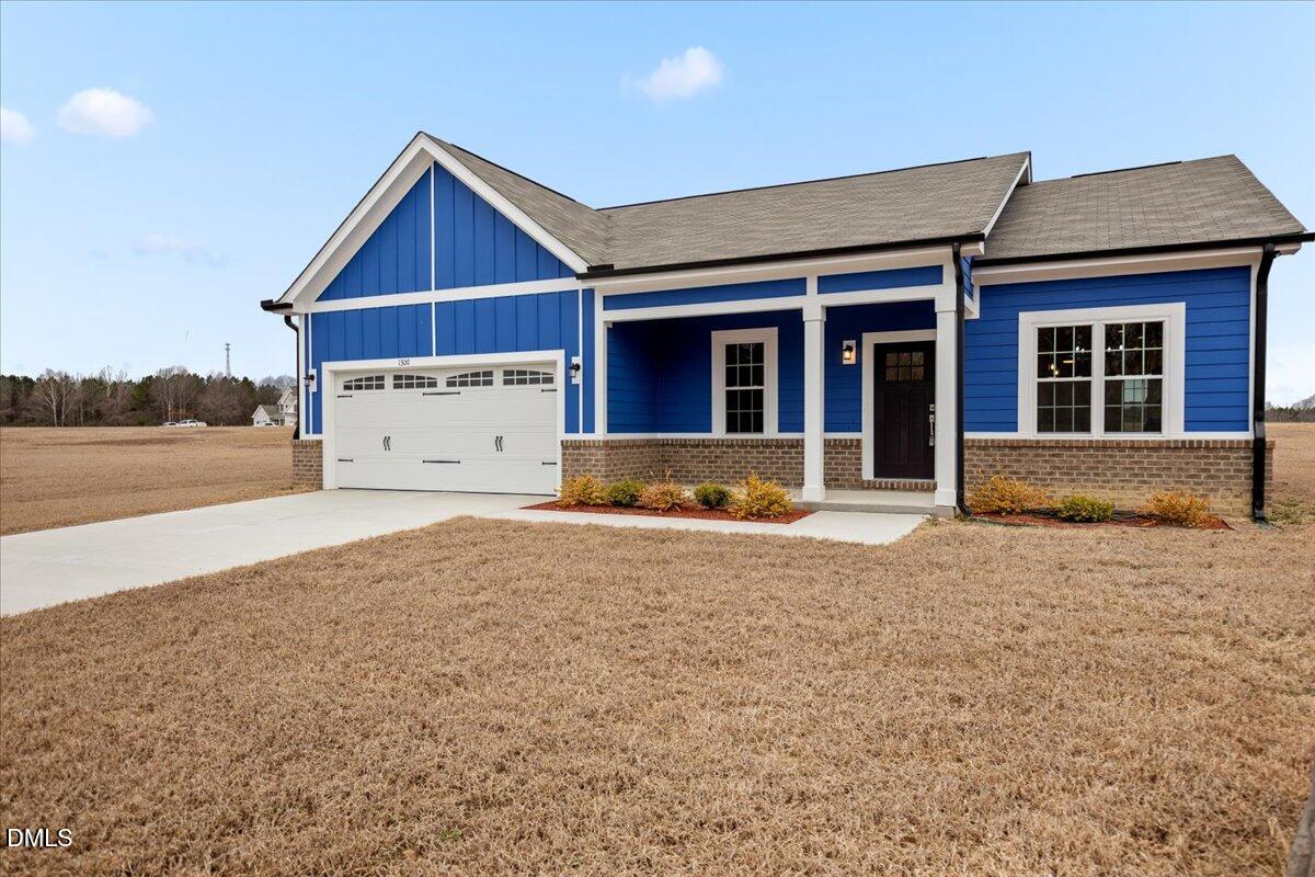 1300 Nick Coley Road Whitakers, NC 27891 - Photo 2 of 47 a front view of a house with a yard and garage