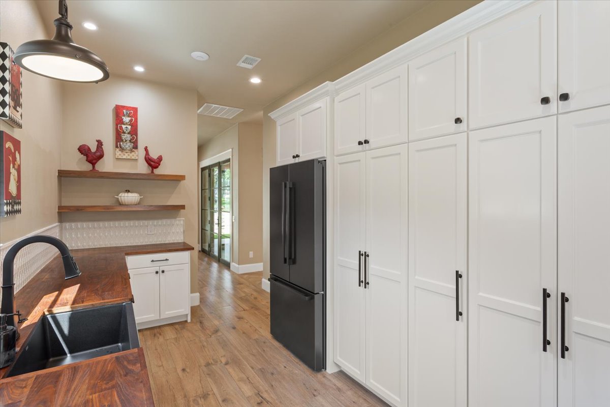 309 Highland Spring Lane Georgetown, TX 78633 - Photo 14 of 40 And on the other side of the Butler's Pantry, there are cabinets of pantry shelves for canned & dry goods. Floating Walnut Shelves. Room for a 2nd refrigerator...