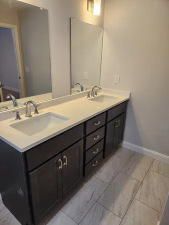 a bathroom with a sink vanity and mirror