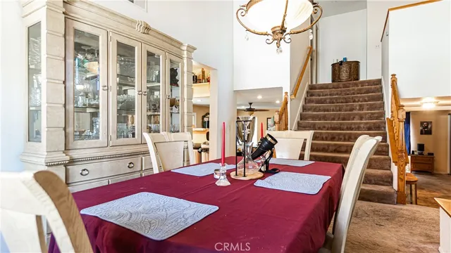 a view of a dining room with furniture and chandelier
