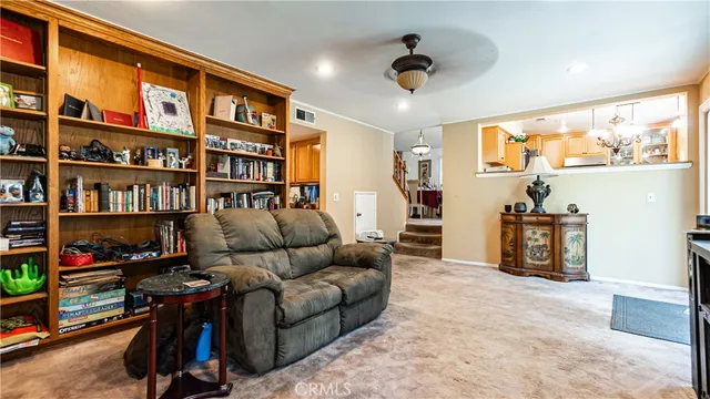 a living room with furniture gym equipment and a flat screen tv
