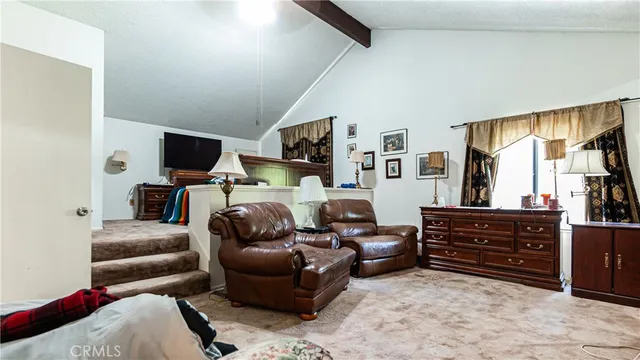 a living room with furniture a flat screen tv and dresser