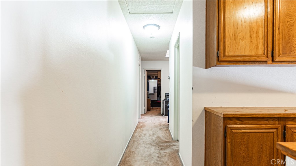 24220 Mentry Drive Newhall, CA 91321 - Photo 31 of 50 a view of a hallway with wooden floor
