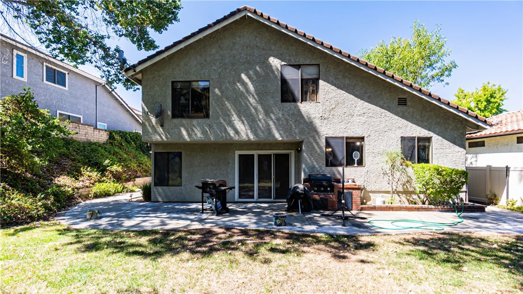 24220 Mentry Drive Newhall, CA 91321 - Photo 37 of 50 a front view of a house with a yard outdoor seating and covered with trees