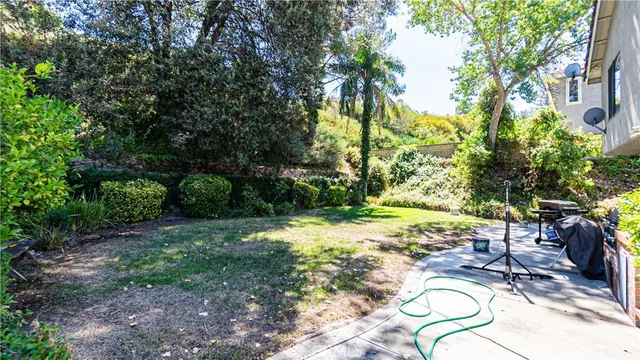 a view of a swimming pool with a patio and a garden