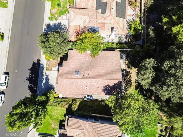 an aerial view of a house with a yard and garden