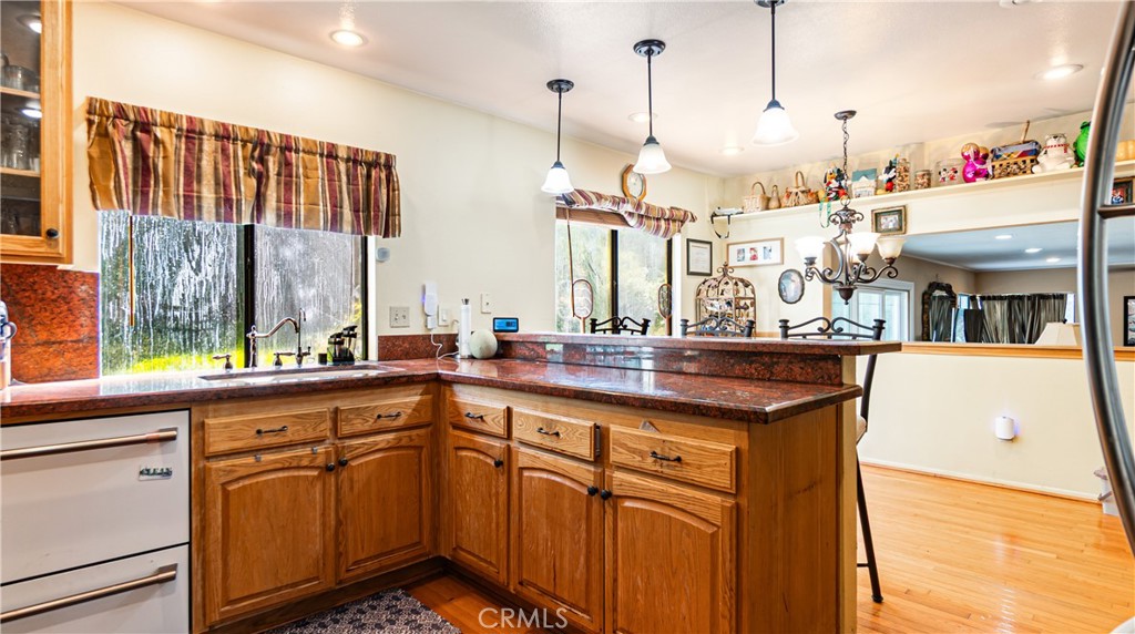 24220 Mentry Drive Newhall, CA 91321 - Photo 6 of 50 a open kitchen with a sink and dishwasher with wooden floor