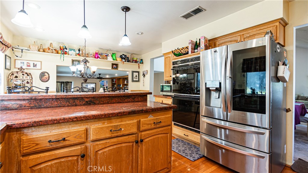 24220 Mentry Drive Newhall, CA 91321 - Photo 9 of 50 a kitchen with stainless steel appliances granite countertop a refrigerator and a stove
