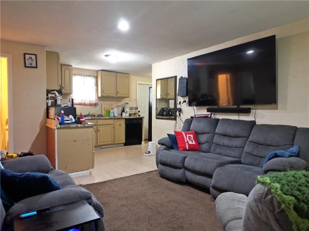 1119 Layton Road Butler, PA 16001 - Photo 5 of 25 a living room with furniture and a flat screen tv