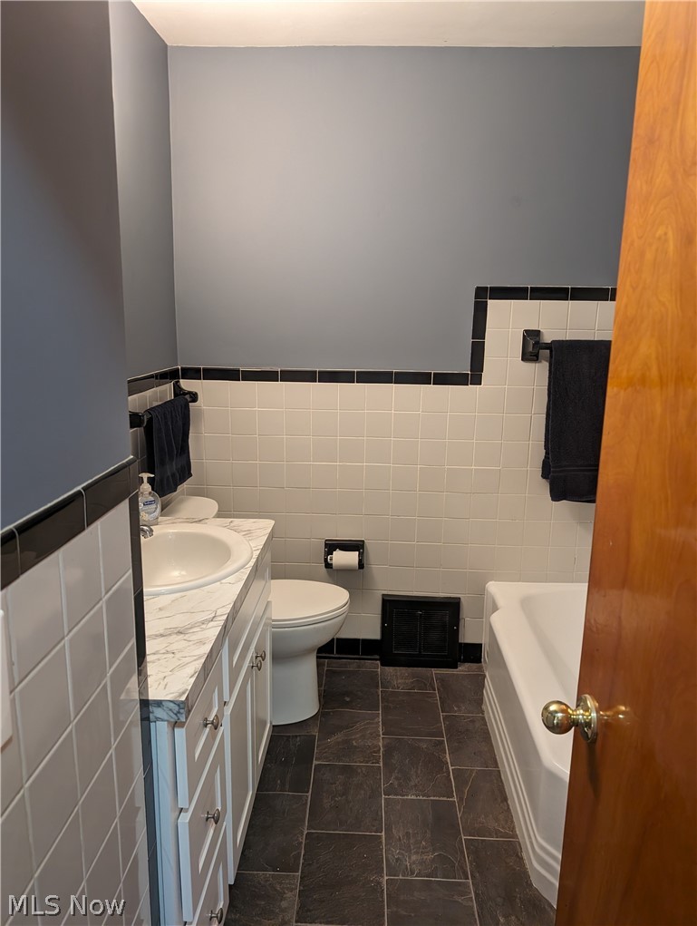 30213 Barjode Road Willowick, OH 44095 - Photo 7 of 20 Bathroom featuring tile walls, tile flooring, vanity, and toilet