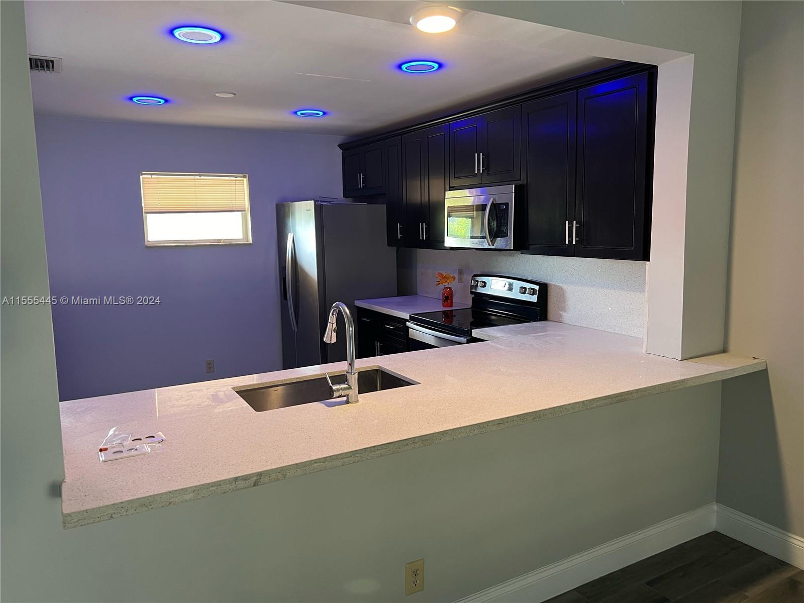 8765 Azalea Court, Unit 202 Tamarac, FL 33321 - Photo 1 of 9 a bathroom with a sink and a mirror