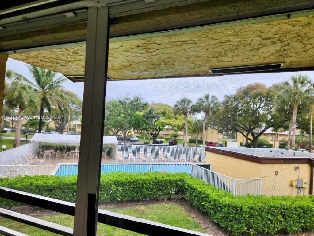 8765 Azalea Court, Unit 202 Tamarac, FL 33321 - Photo 5 of 9 a view of a garden from a window