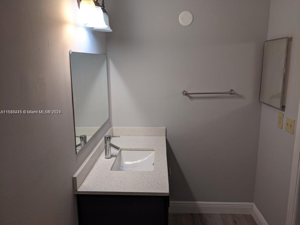 8765 Azalea Court, Unit 202 Tamarac, FL 33321 - Photo 9 of 9 a bathroom with a sink toilet and vanity